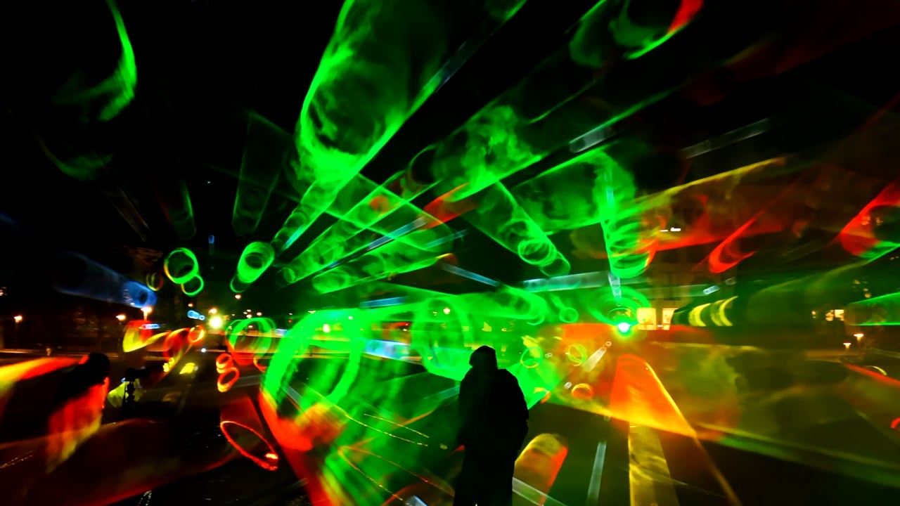 A dense green lightfield filling the air above the forum, one visitor silhouetted against it