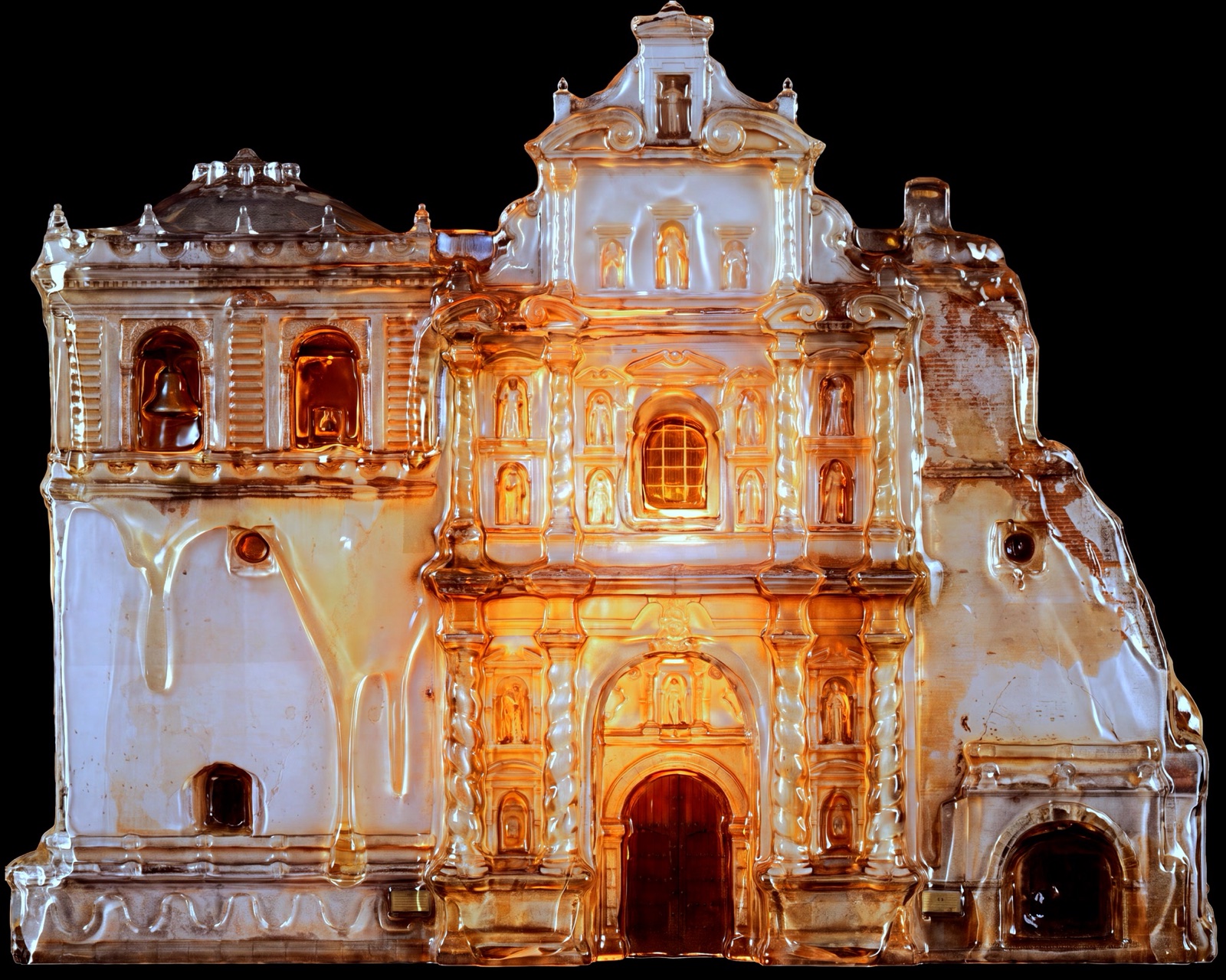 The baroque façade of the San Francisco church in La Antigua Guatemala rendered in golden light by a projection mapping