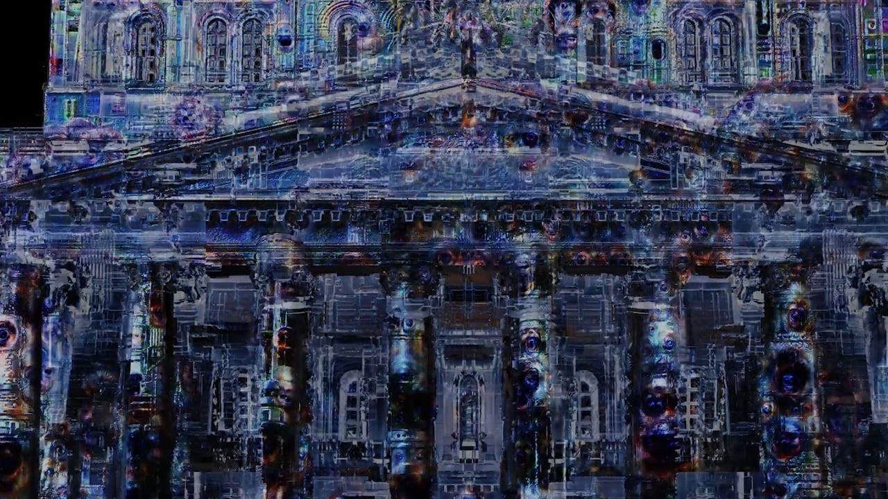 The Bolshoi Theatre in Moscow covered in a dark, textured 3D projection mapping with glowing cracks and colours