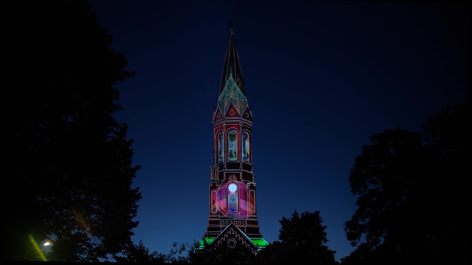 Thin white lines tracing the architecture of the Emmauskirche tower, with a glowing pink orb over the window below