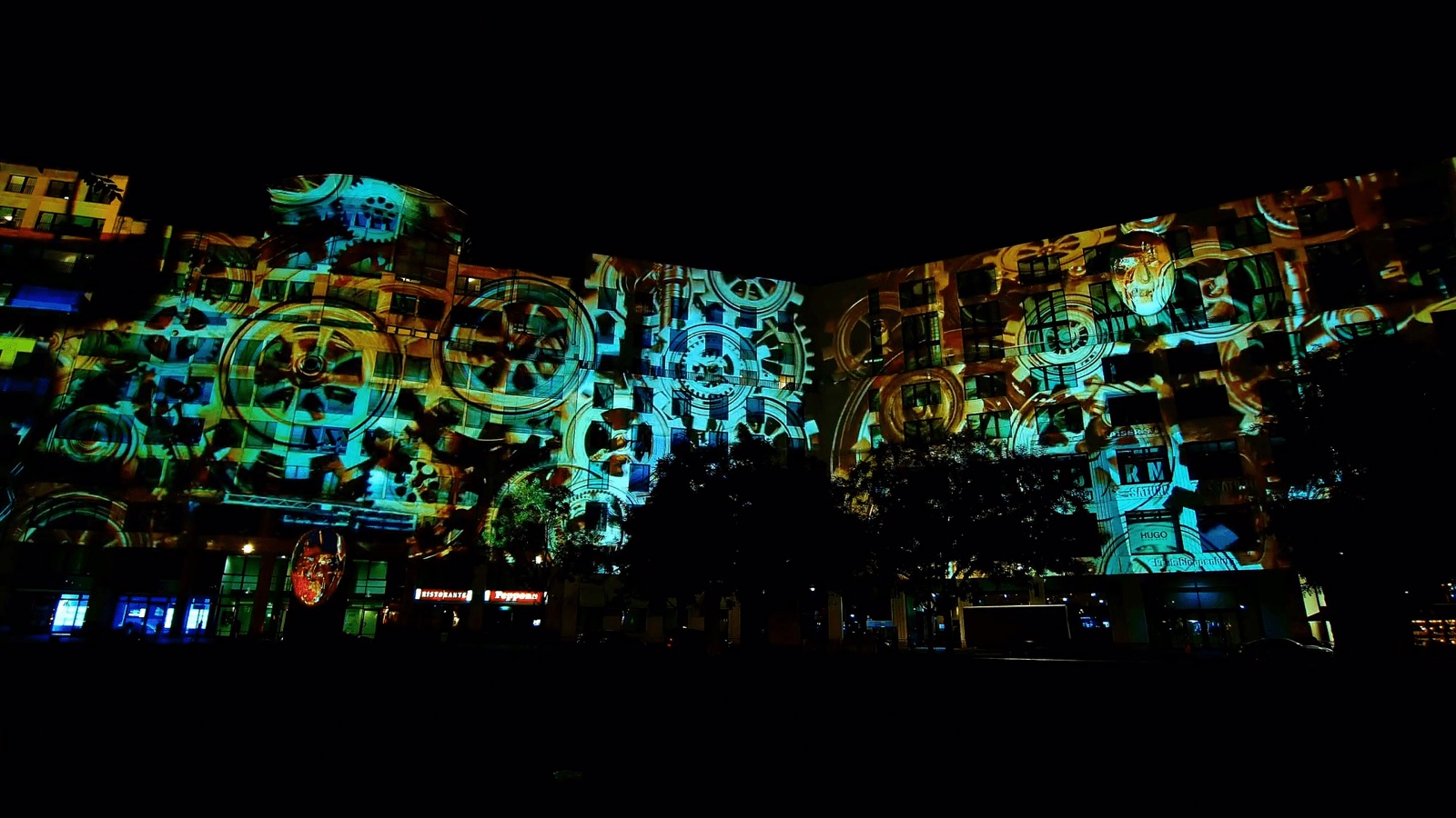 The long façade of the Mall of Berlin at Leipziger Platz covered by a large-scale 3D projection mapping at night