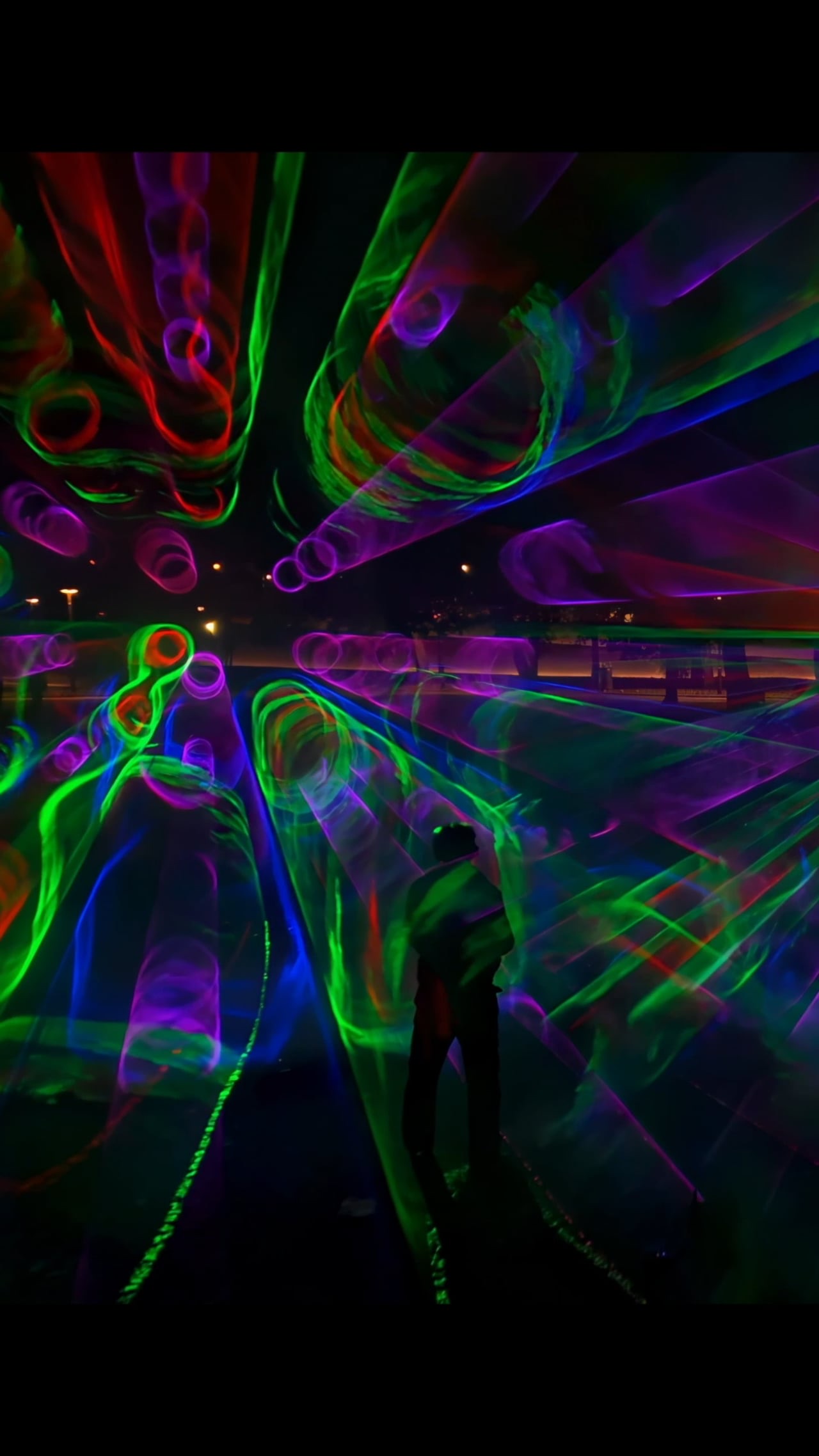 Beams of pink, green and blue light drawn through fog at the Marx-Engels-Forum, Berlin, 2023