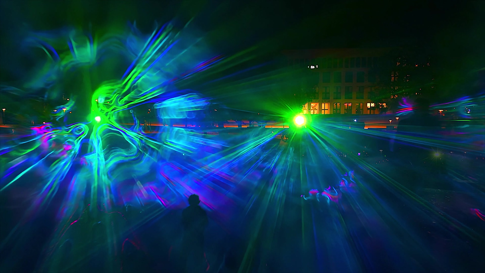Beams of pink, green and blue light drawn through fog at the Marx-Engels-Forum, Berlin, 2023
