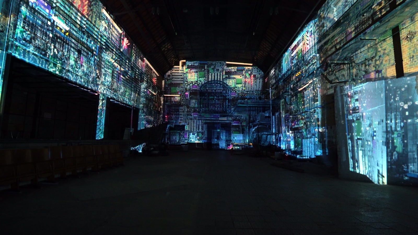 The brick walls of the MaHalla industrial hall in Berlin wrapped in a blue and cyan projection mapping