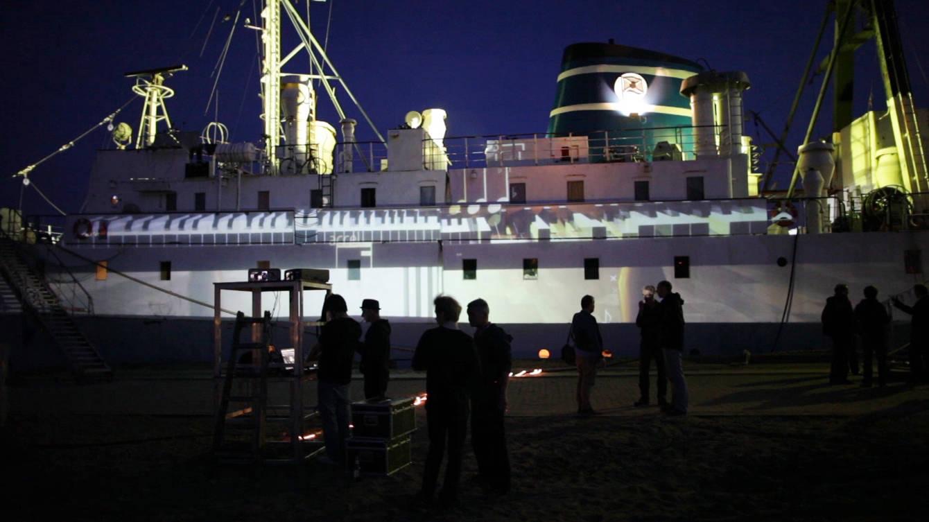 The hull of the ship MS Stubnitz in Hamburg harbour lit by projection mapping during the Elbjazz Festival