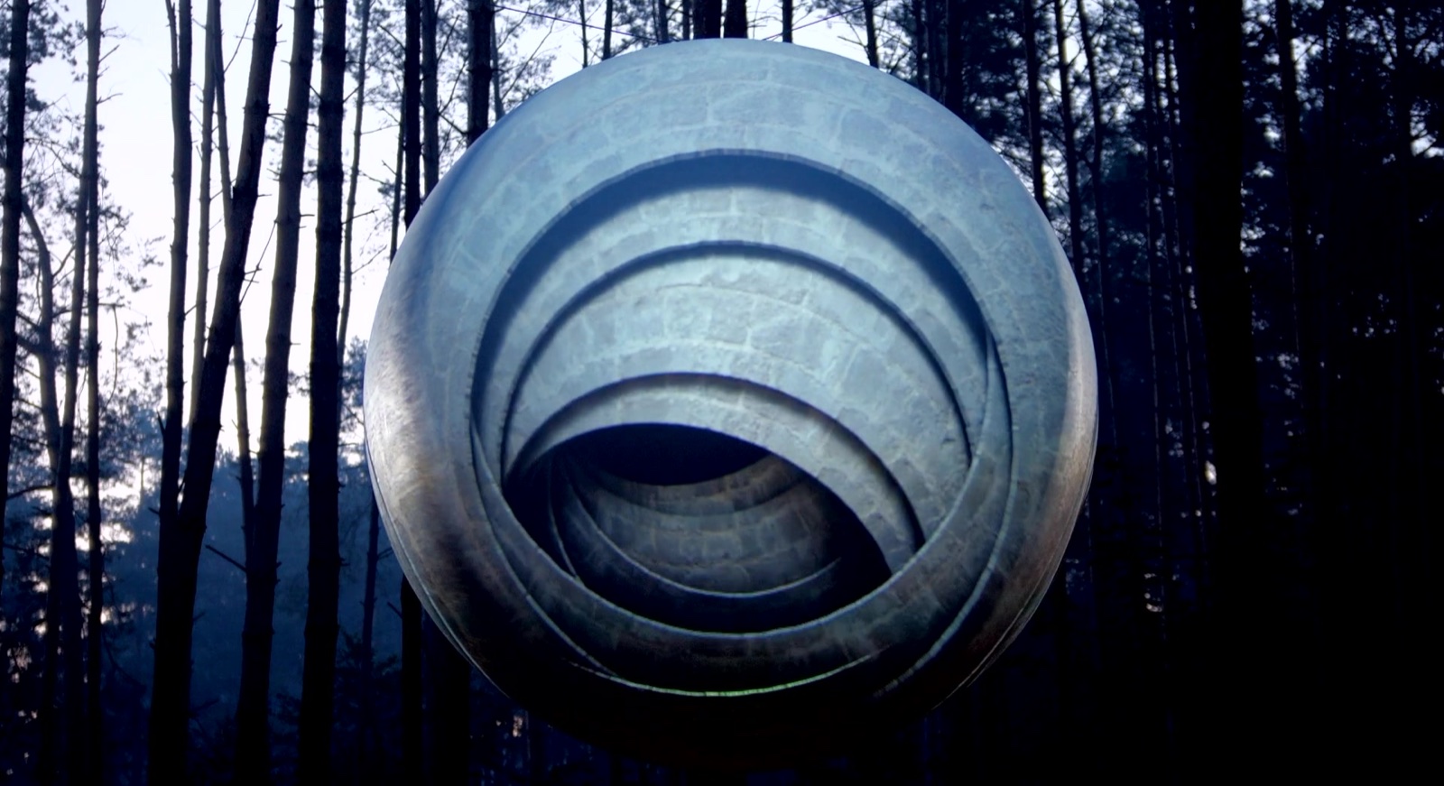 A large sphere standing among trees, covered in a concentric blue projection mapping at Garbicz Festival