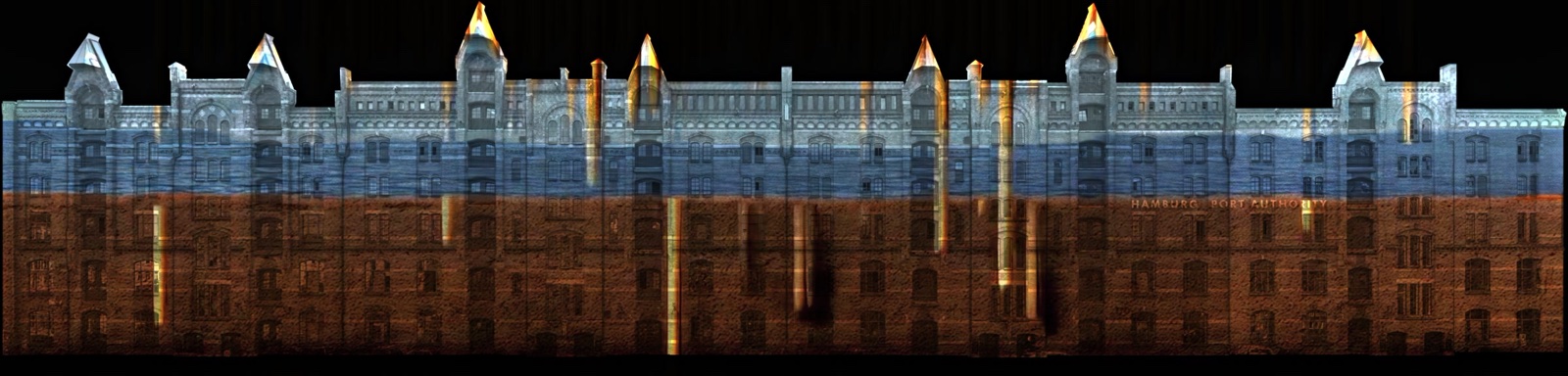 The long red-brick warehouse row of Hamburg’s Speicherstadt rendered in a panoramic projection mapping