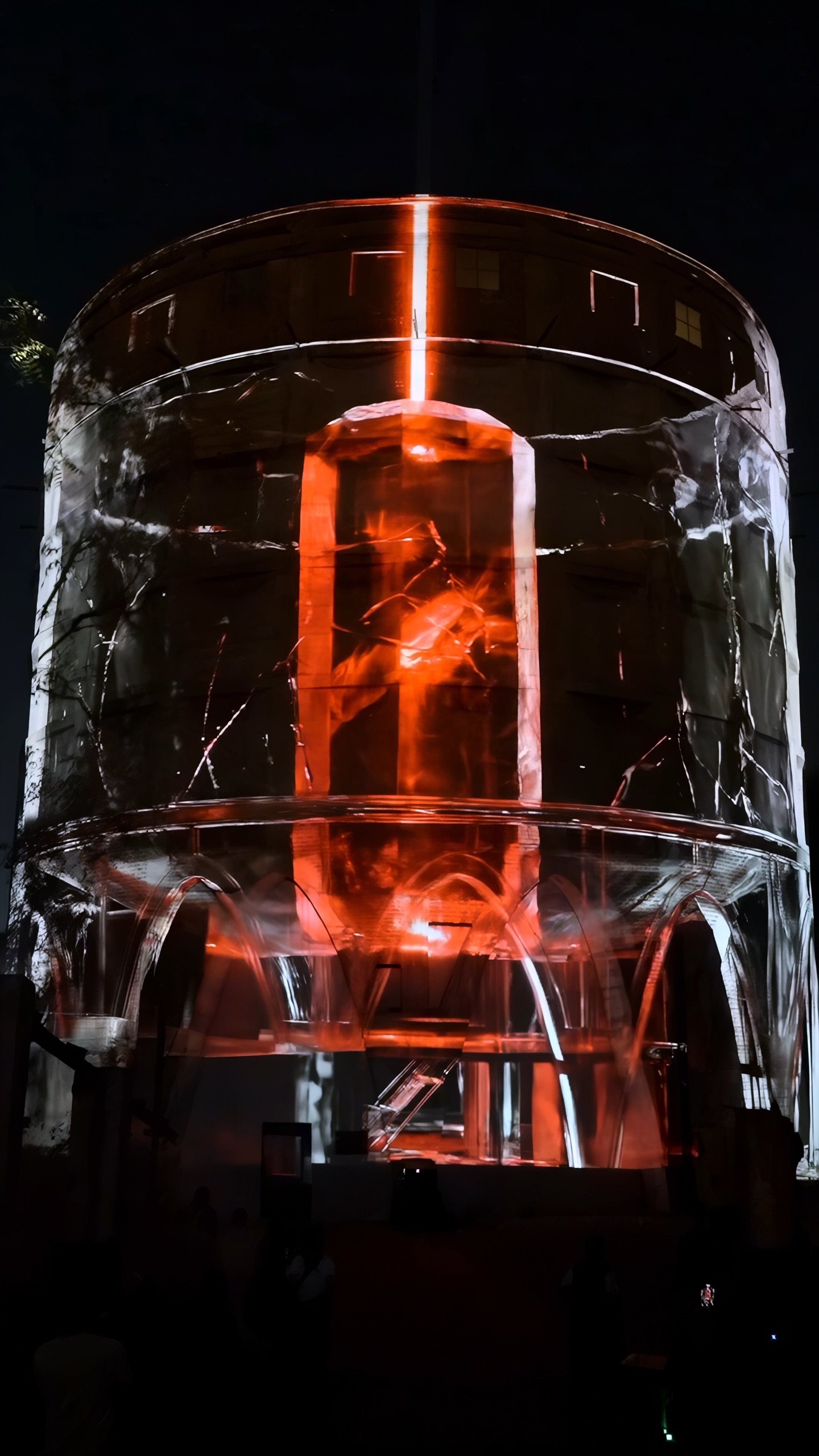 A vertical column of orange fire running up the inside of the projected glass cylinder, the structure around it rendered in cool white